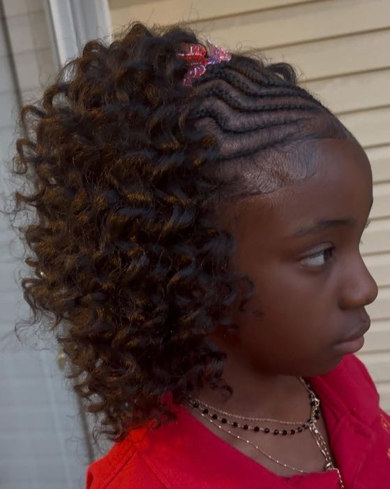 Child's curly braided style with a hair clip accent