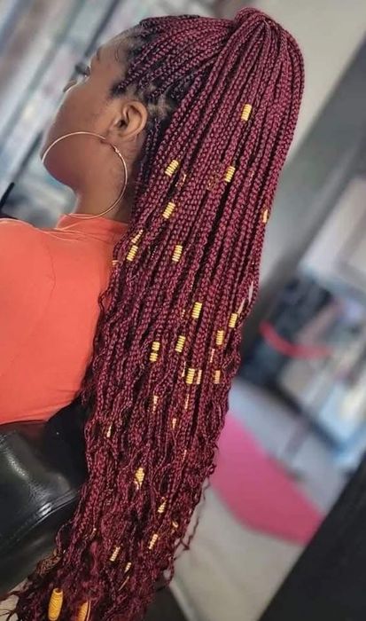 Burgundy knotless braids with gold beaded accents, side profile