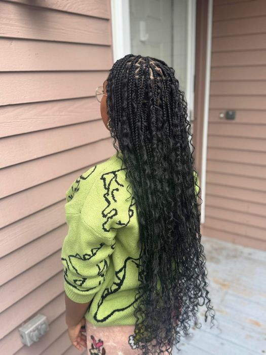 Long knotless braids with curly ends, outdoor natural light