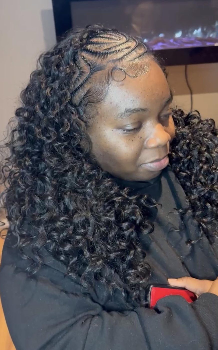 Intricate geometric feed-in braid parting at the crown into curly hair